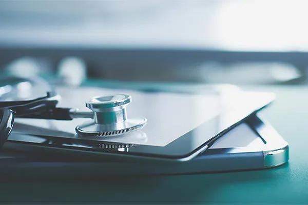 Close up of a stethoscope lying on a tablet, representing advanced functional medicine testing offered by Morgan Burns, APRN in New Smyrna Beach.