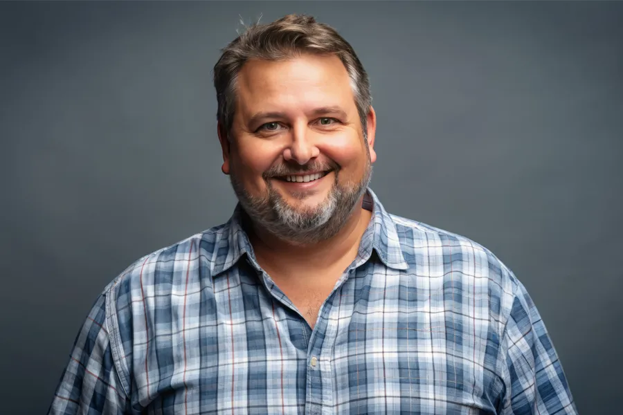 A happy, slightly overweight man with a beard. Get treatment for high cholesterol from Morgan Burns, APRN in New Smyrna Beach.