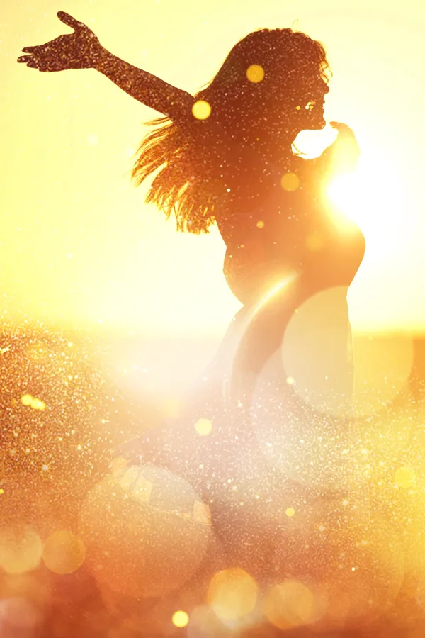 A woman with outstretched arms in the sunset. Get Neuro-Longevity Peptides treatment from Morgan Burns, APRN in New Smyrna Beach.