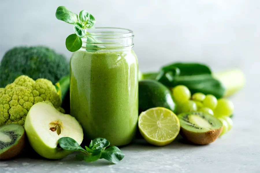 A tableau of healthy green fruits and vegetables and juices. Get nutritional counseling from Morgan Burns, APRN in New Smyrna Beach.