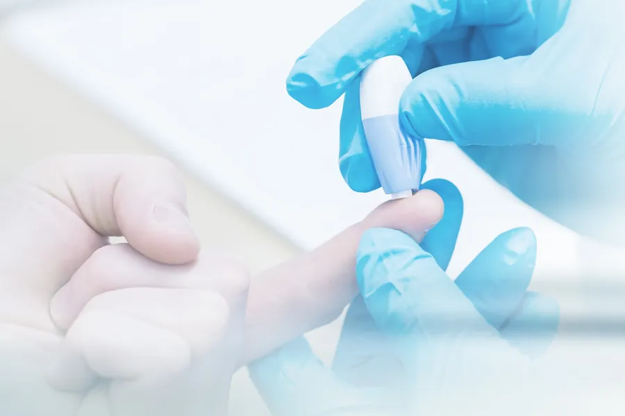 Gloved hand performing a blood sugar check with a lancet. Morgan Burns, APRN offers expert Functional Medicine for Type 2 Diabetes care in New Smyrna Beach.