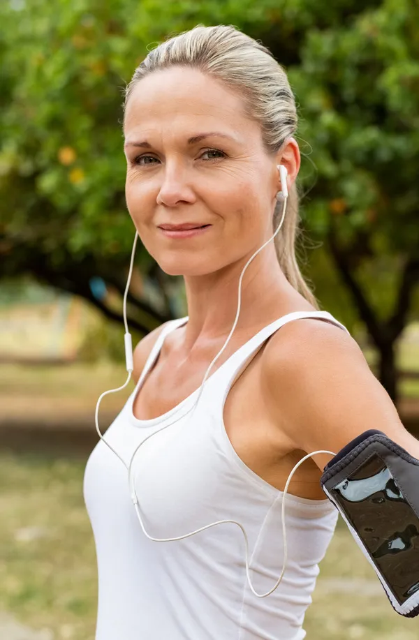 Evolve-Body-Contouring-Treatment A mature woman with smooth healthy skin prepares for a run. Get Evolve body contouring treatment from Brandi Terra, NP at Oak & Stone Wellness in San Diego.