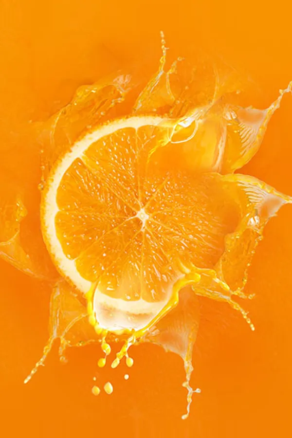 An orange slice dropped into orange juice. Get High Dose Vitaman C IV treatment from Brandi Terra, NP at Oak & Stone Wellness in San Diego.