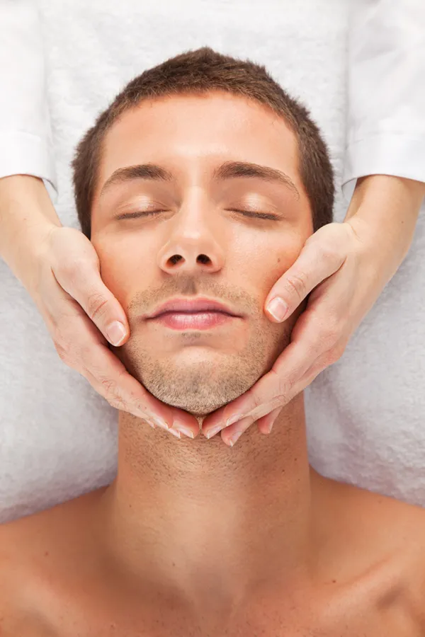 A man receives a hydrafacial treatment from Brandi Terra, NP at Oak & Stone Wellness in San Diego.